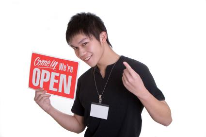Man with open sign for business