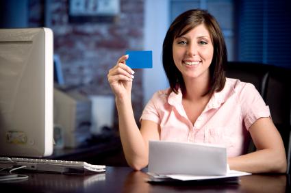 Woman at Computer Holding Business Card