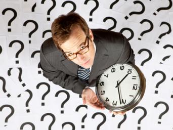 Businessman holding a clock