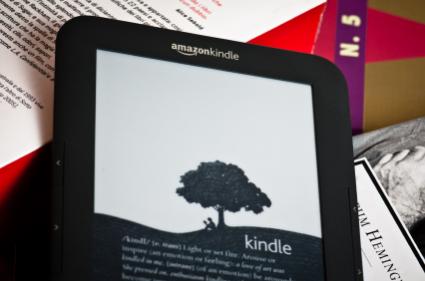 Amazon Kindle resting on books
