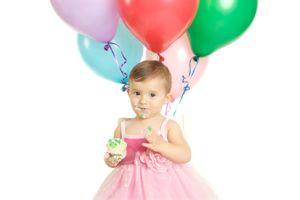 Little girl in party dress with balloons