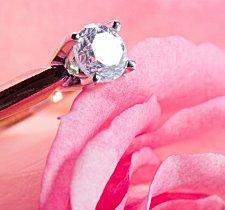 Engagement ring on rose petal