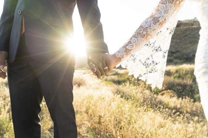 Couple holding hands at wedding