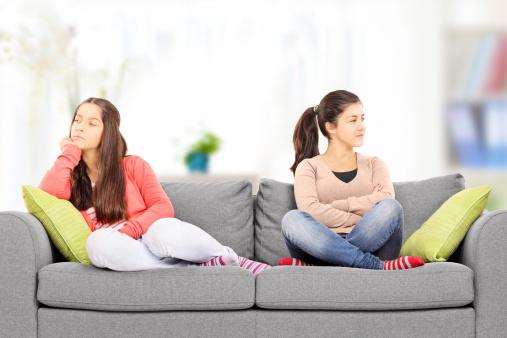 Teenage girls sitting on sofa
