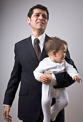 Businessman holding a baby