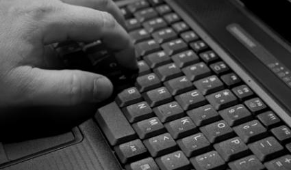 Black and white hand on keyboard