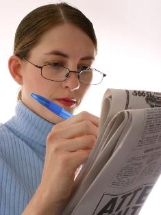 woman searching classified ads