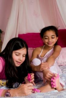 Two young girls painting toenails