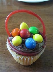 A cupcake decorated like an Easter basket.