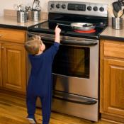 Toddler reaching for a hot stove on the pan