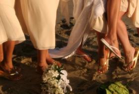 bride and bridesmaids' shoes on beach