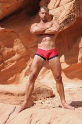 Man in red and black trunks