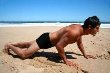 Man doing pushups in square cut trunks