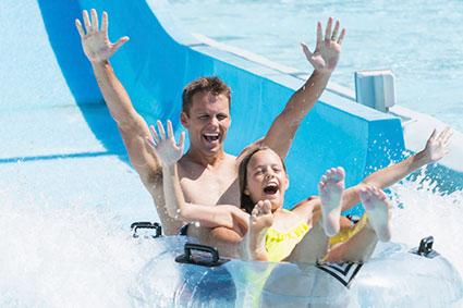 father and daughter on water slide