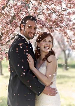 Bride and groom showered with cherry blossoms