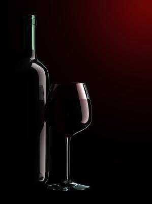 Wine bottle and glass in shadow.