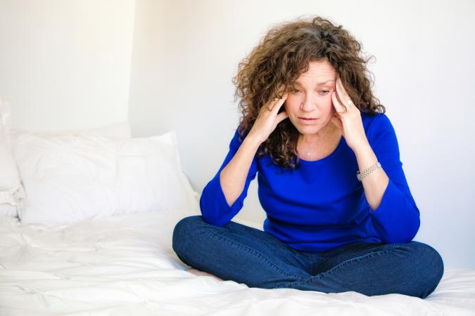 female sitting on bed