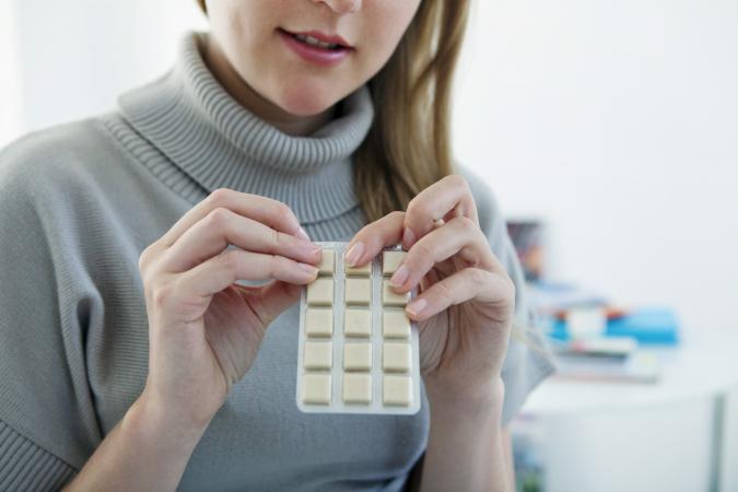woman holding package of Nicotine Gum