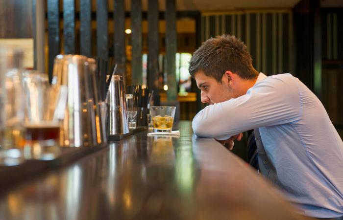 Man drinking alone at the bar