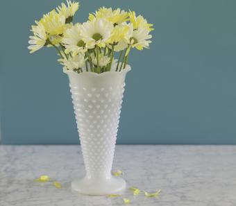 White milkglass hobnail vase with daisies