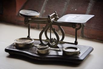 Close-Up Of Antique Weight Scale On Table