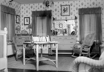 Interior furnishings of a turn of the 20th century bedroom with wicker rocking chairs