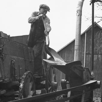 Man grinding feed at home