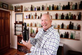 Man with his antique bottle collection