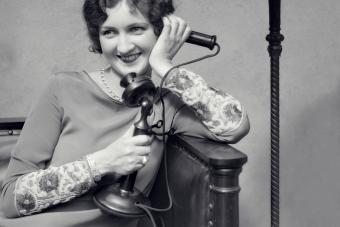 Woman On Candle Stick Phone Sitting On Couch