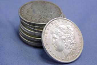 stack of old U.S. silver dollars from the late 19th century