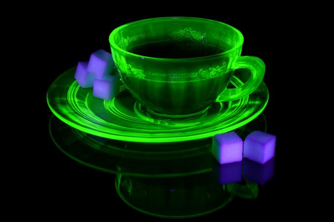 A glowing uranium glass teacup and saucer
