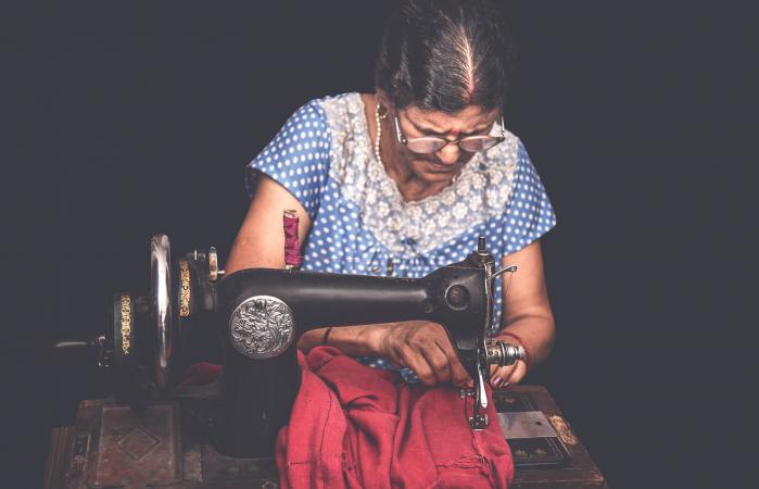 woman sewing clothes with sewing machine