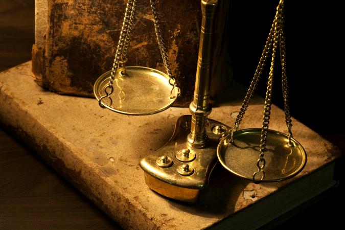 Ancient scale and old books on wooden table
