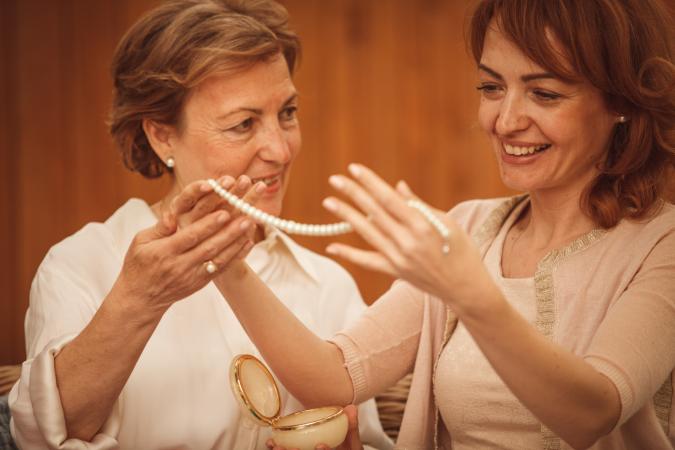 Mother giving daughter heirloom necklace