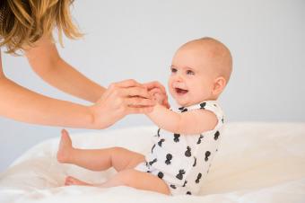 Mother and baby daughter on bed