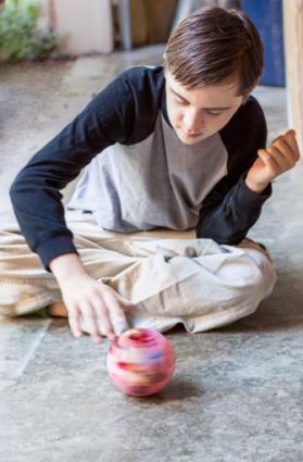 Boy spinning ball