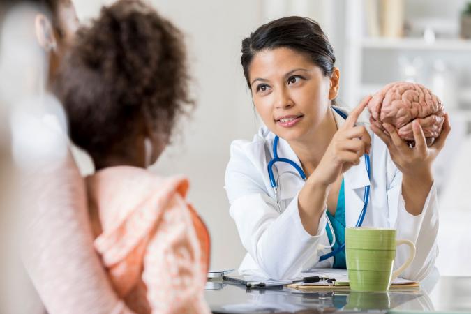 Pediatric neurologist consulting with patient's mom