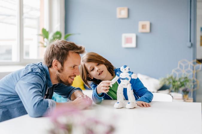adult and child playing robots