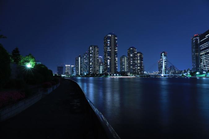 Illuminated City Against Blue Night Sky