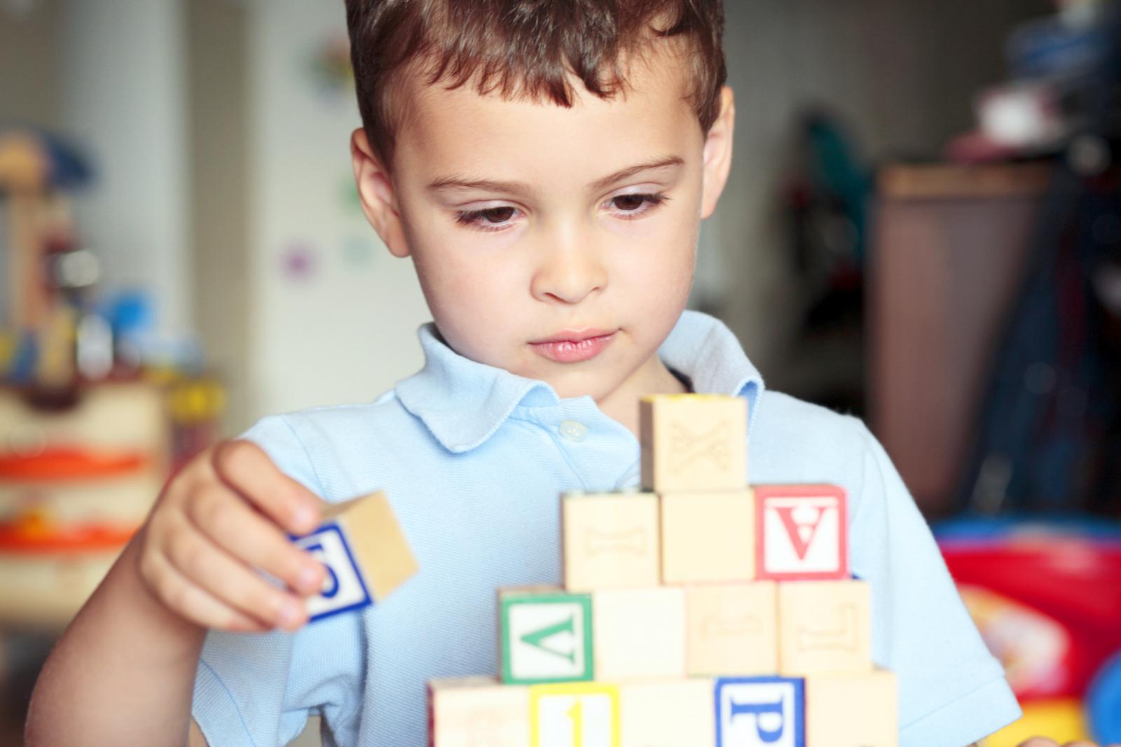 Autistic boy building with blocks