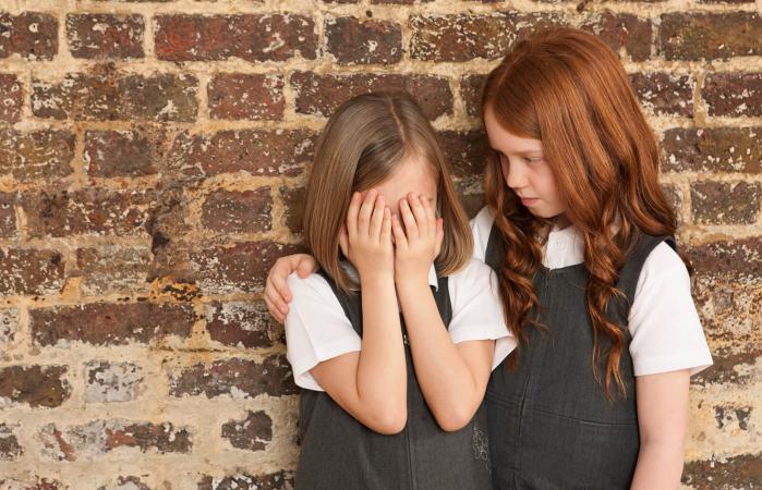 Girl comforting her friend