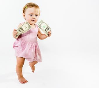 Baby girl running with dollar bills