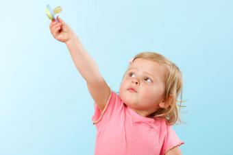 Girl holding pacifier