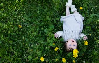 baby girl lying in the grass