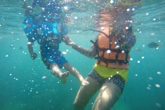 Woman And Boy Swimming Undersea 