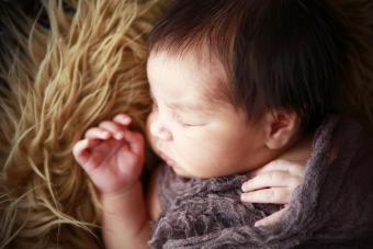 Newborn Sleeping on Fur Rug