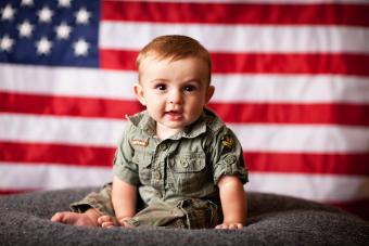 Patriotic baby boy with American flag background 