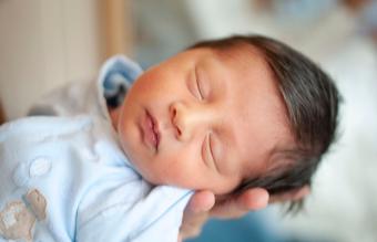 Mother holding her newborn baby boy