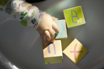 Baby picking up blocks