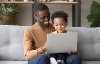 dad and son play computer game 